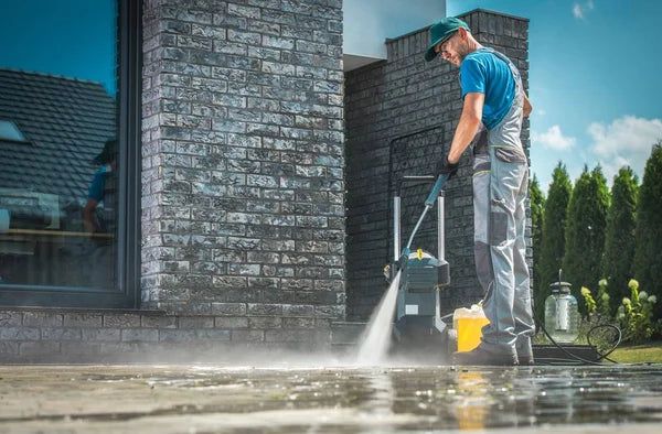 depositphotos 206410300 stock photo pressure washer cleaning front house
